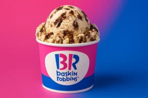 Scoop of Baskin Robbins ice cream in branded cup on vibrant pink and blue background