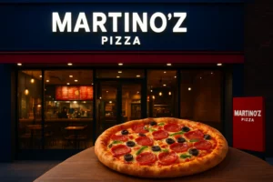 Martino’z Pizza restaurant exterior with vibrant lights and fresh pizza on table, symbolizing franchise expansion in India