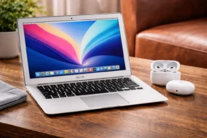 Refurbished Apple MacBook Air 2017 displayed next to AirPods Pro highlighting a major price drop making the laptop cheaper than earbuds
